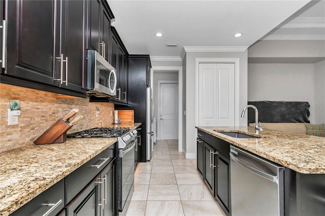 7210 SW 179th Ct, Dunnellon, FL 34432 - kitchen with stainless steel appliances, a sink, crown molding, tasteful backsplash, and light stone countertops