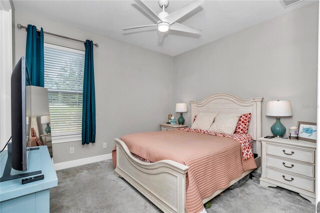 7210 SW 179th Ct, Dunnellon, FL 34432 - bedroom with light colored carpet, baseboards, and ceiling fan