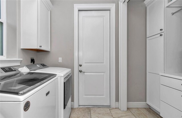 7210 SW 179th Ct, Dunnellon, FL 34432 - laundry area featuring cabinet space, washer and clothes dryer, and baseboards