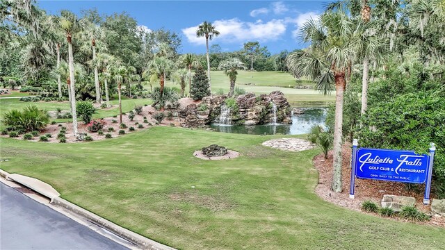 7210 SW 179th Ct, Dunnellon, FL 34432 - view of community featuring a lawn, view of scattered trees, golf course view, and a water view