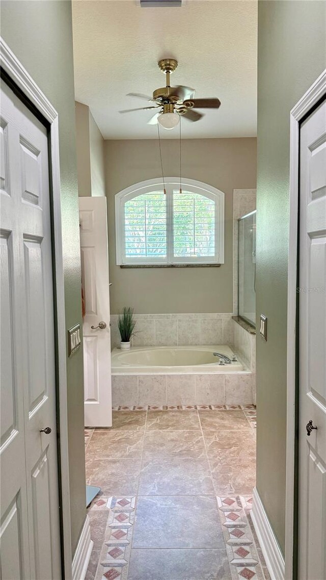 1138 Lumsden Trace Cir, Valrico, FL 33594 - full bathroom with a bath, ceiling fan, and a shower with shower door