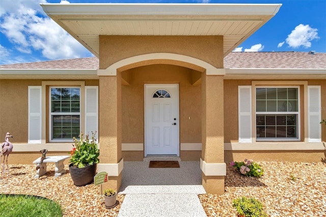 16969 SW 40th Cir, Ocala, FL 34473 - view of exterior entry featuring roof with shingles and stucco siding