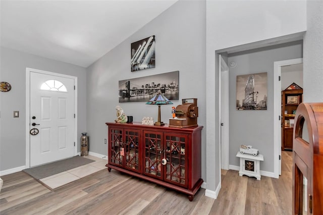16969 SW 40th Cir, Ocala, FL 34473 - entryway featuring wood finished floors, lofted ceiling, and baseboards