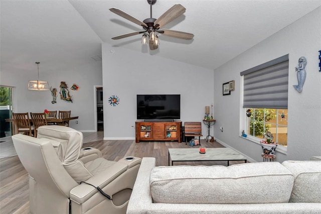 16969 SW 40th Cir, Ocala, FL 34473 - living area featuring lofted ceiling, light wood-style flooring, ceiling fan, and baseboards