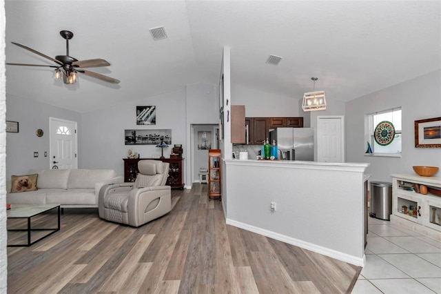 16969 SW 40th Cir, Ocala, FL 34473 - living area featuring ceiling fan, lofted ceiling, light wood-style floors, and baseboards