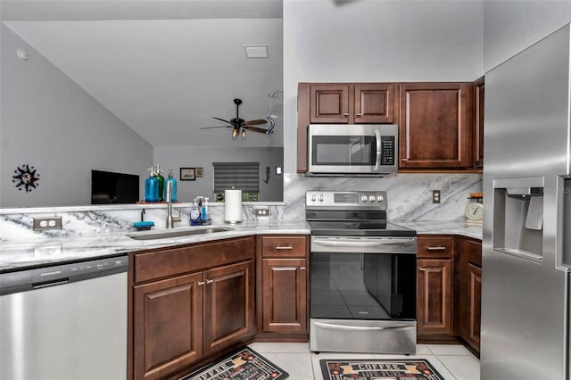 16969 SW 40th Cir, Ocala, FL 34473 - kitchen with stainless steel appliances, a sink, light tile patterned floors, a ceiling fan, and backsplash