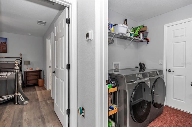 16969 SW 40th Cir, Ocala, FL 34473 - laundry room with washer and clothes dryer and wood finished floors