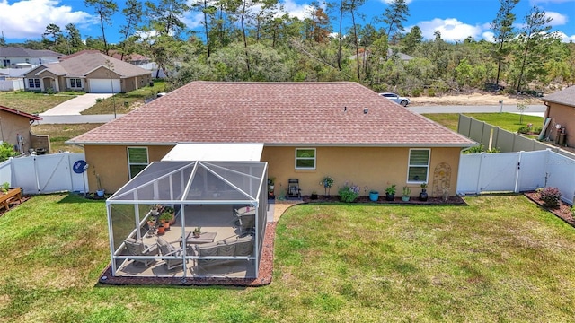16969 SW 40th Cir, Ocala, FL 34473 - rear view of house with a gate, stucco siding, glass enclosure, and a shingled roof