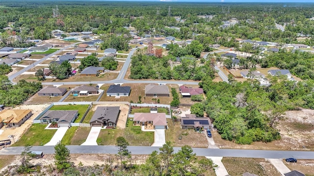 16969 SW 40th Cir, Ocala, FL 34473 - aerial view of property's location with nearby suburban area and a heavily wooded area