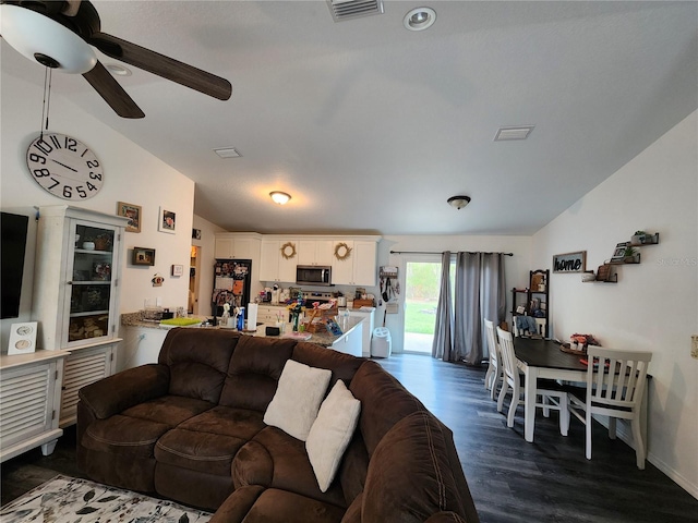 120 Fisher Ct, Ocklawaha, FL 32179 - living area featuring vaulted ceiling, ceiling fan, dark wood finished floors, and baseboards