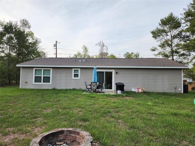 120 Fisher Ct, Ocklawaha, FL 32179 - back of house featuring a fire pit, a yard, and roof with shingles