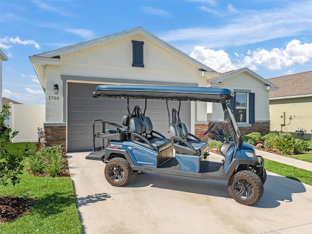 7206 SW 60th Ln, Ocala, FL 34474 - view of front of home featuring stone siding, concrete driveway, stucco siding, and an attached garage