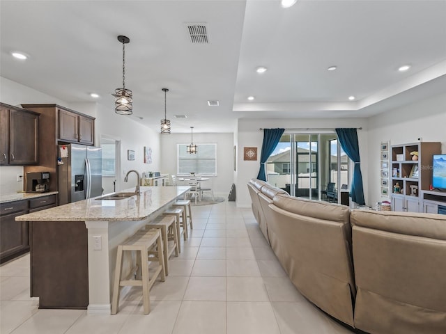 7206 SW 60th Ln, Ocala, FL 34474 - kitchen featuring stainless steel refrigerator with ice dispenser, a sink, open floor plan, dark brown cabinets, and recessed lighting