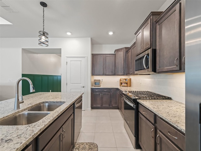 7206 SW 60th Ln, Ocala, FL 34474 - kitchen with stainless steel appliances, a sink, dark brown cabinets, decorative light fixtures, and decorative backsplash