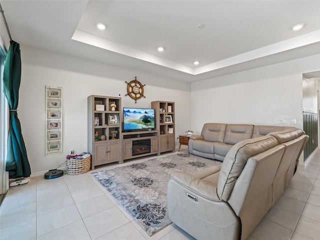 7206 SW 60th Ln, Ocala, FL 34474 - living area featuring recessed lighting, light tile patterned flooring, a tray ceiling, baseboards, and a glass covered fireplace