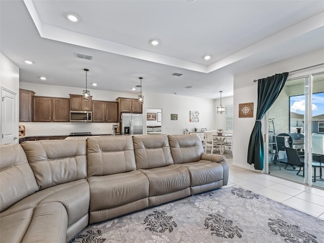 7206 SW 60th Ln, Ocala, FL 34474 - living area with recessed lighting, a tray ceiling, light tile patterned floors, and baseboards