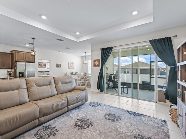 7206 SW 60th Ln, Ocala, FL 34474 - living area featuring light tile patterned flooring, recessed lighting, a raised ceiling, and a chandelier