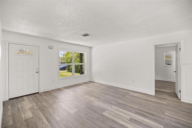 4095 SW 144th St, Ocala, FL 34473 - entrance foyer with a textured ceiling, wood finished floors, and baseboards