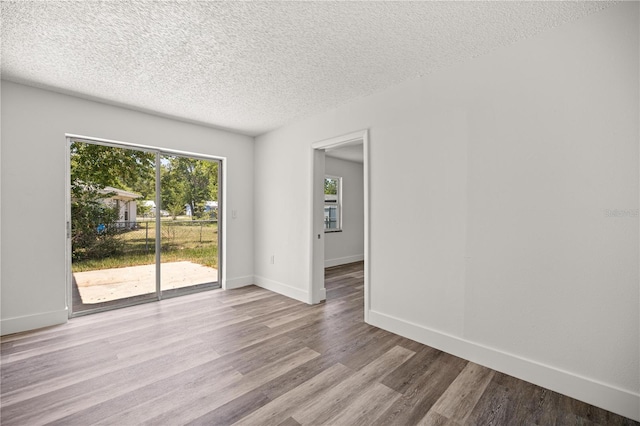 4095 SW 144th St, Ocala, FL 34473 - spare room featuring wood finished floors, a textured ceiling, and baseboards