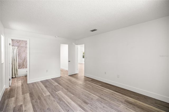 4095 SW 144th St, Ocala, FL 34473 - empty room featuring wood finished floors, baseboards, and a textured ceiling