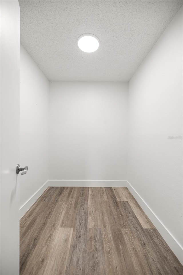 4095 SW 144th St, Ocala, FL 34473 - empty room featuring wood finished floors, a textured ceiling, and baseboards
