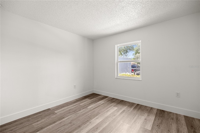 4095 SW 144th St, Ocala, FL 34473 - unfurnished room with light wood-style flooring, baseboards, and a textured ceiling