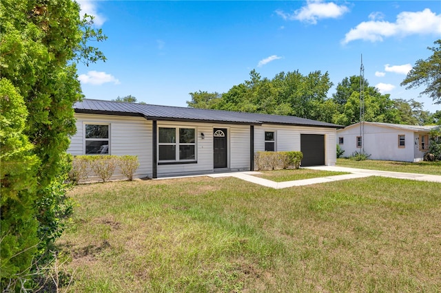 4095 SW 144th St, Ocala, FL 34473 - single story home with a garage, driveway, metal roof, and a front lawn