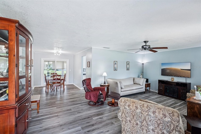 6448 SW 111th Pl, Ocala, FL 34476 - living area with wood finished floors, a ceiling fan, and baseboards