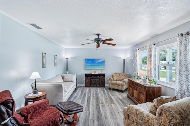 6448 SW 111th Pl, Ocala, FL 34476 - living room with light wood-style floors, a textured ceiling, and ceiling fan