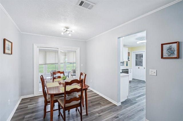 6448 SW 111th Pl, Ocala, FL 34476 - dining area with dark wood finished floors, crown molding, baseboards, a textured ceiling, and a chandelier
