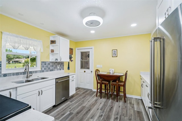 6448 SW 111th Pl, Ocala, FL 34476 - kitchen with appliances with stainless steel finishes, a sink, ornamental molding, white cabinetry, and light countertops
