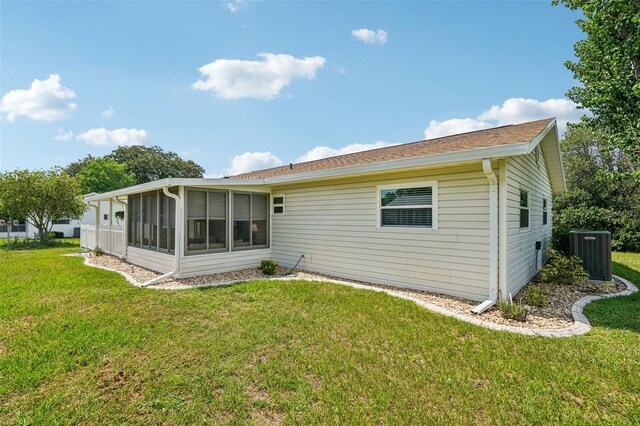 6448 SW 111th Pl, Ocala, FL 34476 - rear view of property featuring cooling unit, a sunroom, and a lawn