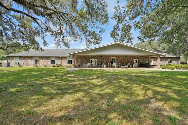6448 SW 111th Pl, Ocala, FL 34476 - back of property featuring a yard, a patio area, central AC unit, and french doors