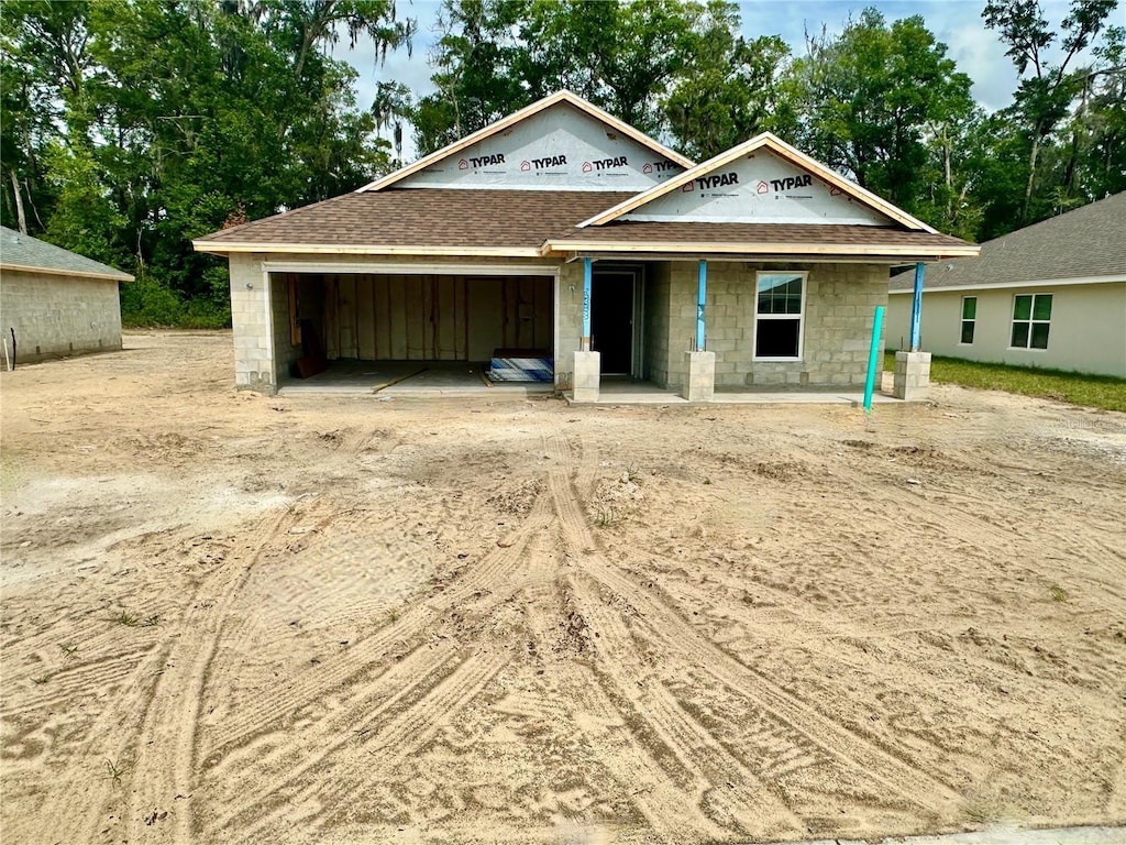 3131 NE 46th Ave, Ocala, FL 34470 - property in mid-construction featuring a garage, dirt driveway, and a shingled roof