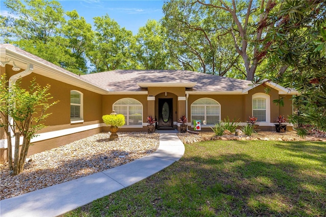 200 SE 145th St, Summerfield, FL 34491 - ranch-style home featuring stucco siding, a front yard, and roof with shingles