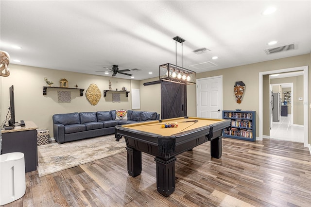 200 SE 145th St, Summerfield, FL 34491 - playroom with a barn door, wood finished floors, recessed lighting, ceiling fan, and billiards table