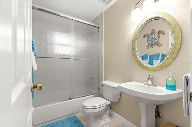 200 SE 145th St, Summerfield, FL 34491 - bathroom with toilet, tile patterned flooring, and combined bath / shower with glass door