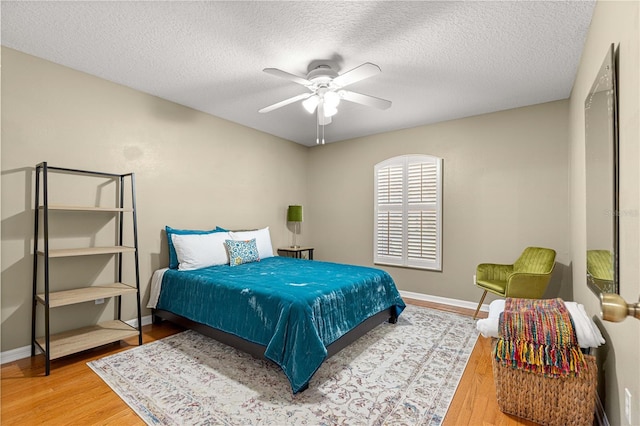 200 SE 145th St, Summerfield, FL 34491 - bedroom featuring wood finished floors, baseboards, a textured ceiling, and ceiling fan
