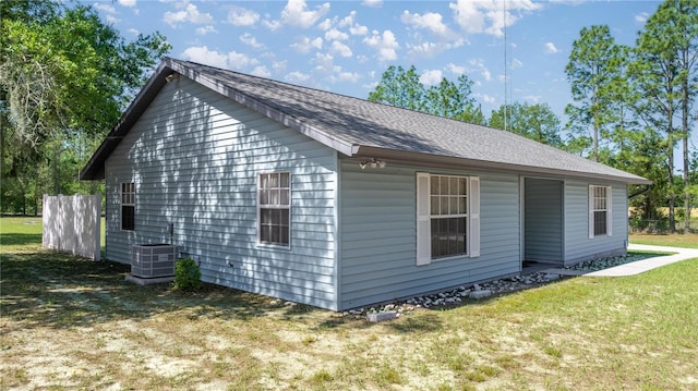 2848 W Henley Ln, Dunnellon, FL 34433 - view of side of property with central AC unit and a lawn
