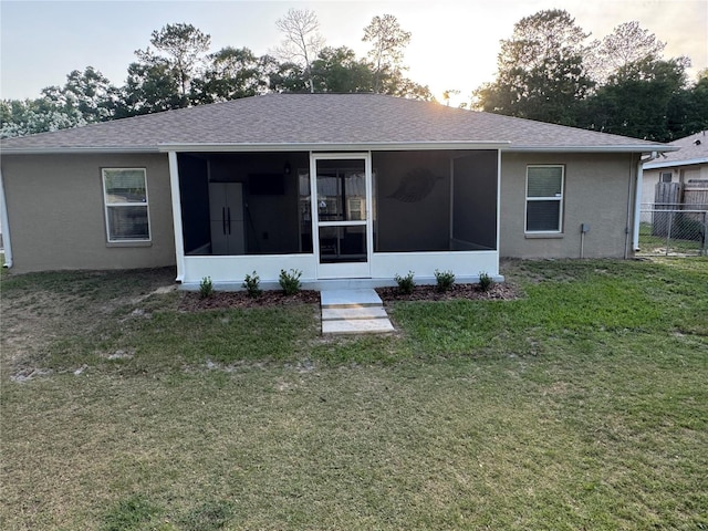 5263 NW 62nd Ave NW, Ocala, FL 34482 - rear view of property with a sunroom, roof with shingles, and stucco siding