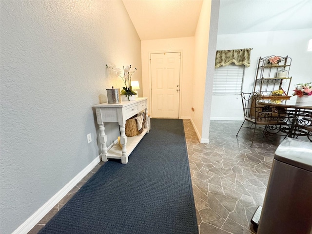 5263 NW 62nd Ave NW, Ocala, FL 34482 - hallway featuring stone flooring, a textured wall, and baseboards