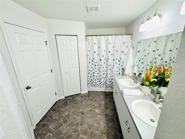 5263 NW 62nd Ave NW, Ocala, FL 34482 - full bathroom featuring double vanity, a shower with curtain, and a textured ceiling