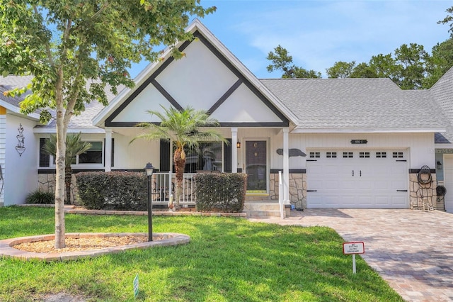 8785 SW 93rd Ln Unit C, Ocala, FL 34481 - view of front of house with a garage, stone siding, decorative driveway, and a porch