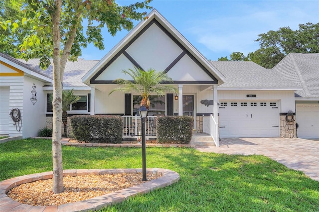8785 SW 93rd Ln Unit C, Ocala, FL 34481 - view of front of home with an attached garage, covered porch, roof with shingles, and decorative driveway