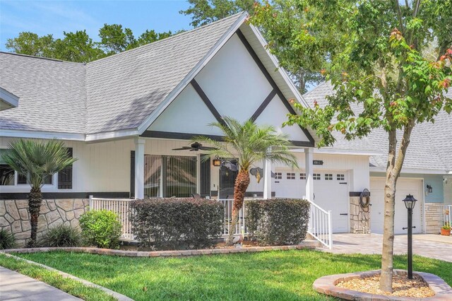 8785 SW 93rd Ln Unit C, Ocala, FL 34481 - view of front facade featuring roof with shingles, concrete driveway, a garage, and stone siding