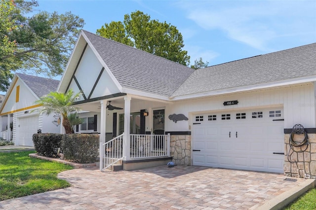 8785 SW 93rd Ln Unit C, Ocala, FL 34481 - view of front of home featuring an attached garage, a shingled roof, driveway, ceiling fan, and stone siding