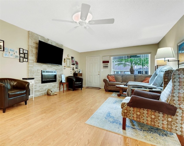 8785 SW 93rd Ln Unit C, Ocala, FL 34481 - living room featuring wood finished floors, a fireplace, and ceiling fan