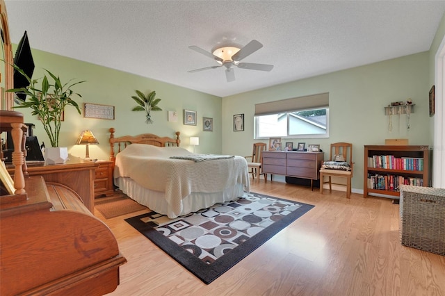 8785 SW 93rd Ln Unit C, Ocala, FL 34481 - bedroom with light wood finished floors, a textured ceiling, and a ceiling fan
