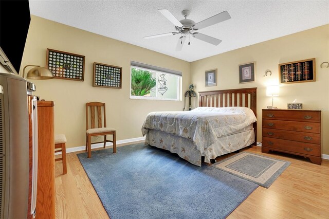 8785 SW 93rd Ln Unit C, Ocala, FL 34481 - bedroom featuring wood finished floors, baseboards, and a textured ceiling