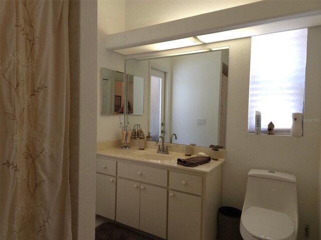 4710 W Mustang Blvd, Beverly Hills, FL 34465 - bathroom with vanity, toilet, and a shower with shower curtain